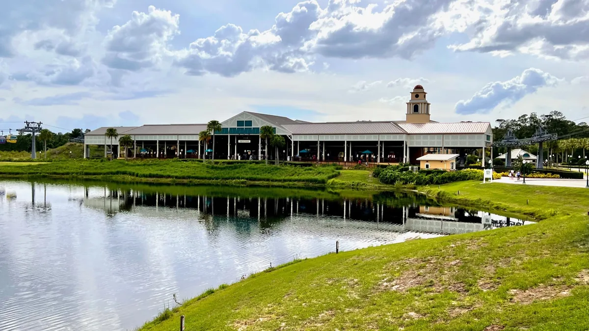 The Skyliner hub station and its Caribbean-style tower beside a lake at Disney's Caribbean Beach Resort