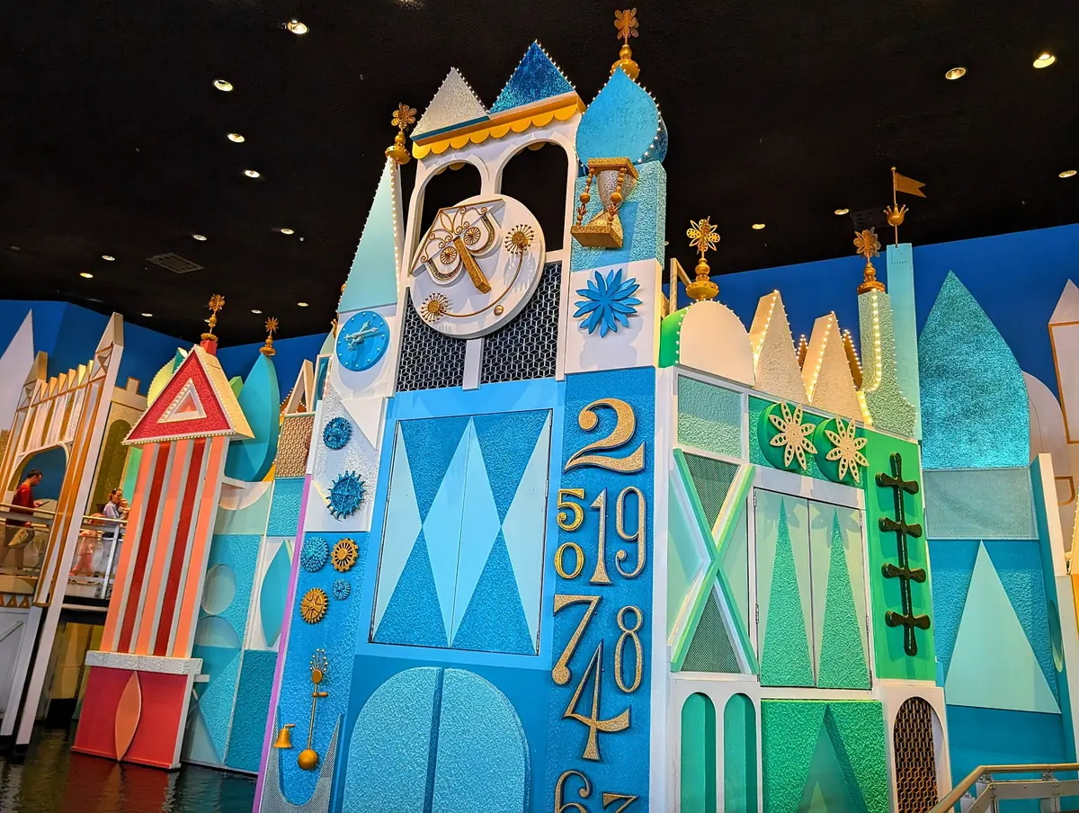 The colorful clock-tower facade of it's a small world's loading area in Fantasyland at Magic Kingdom