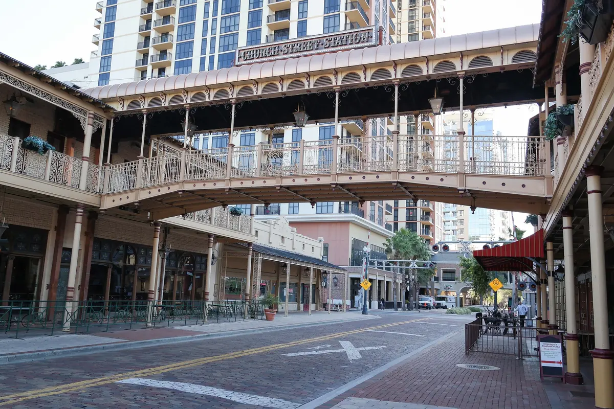 Church Street in downtown Orlando with its ornate iron footbridge and high-rises behind