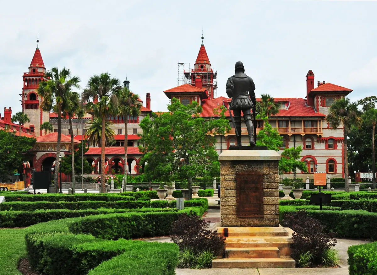 Flagler College's red-roofed Spanish Renaissance towers seen across formal gardens in St. Augustine