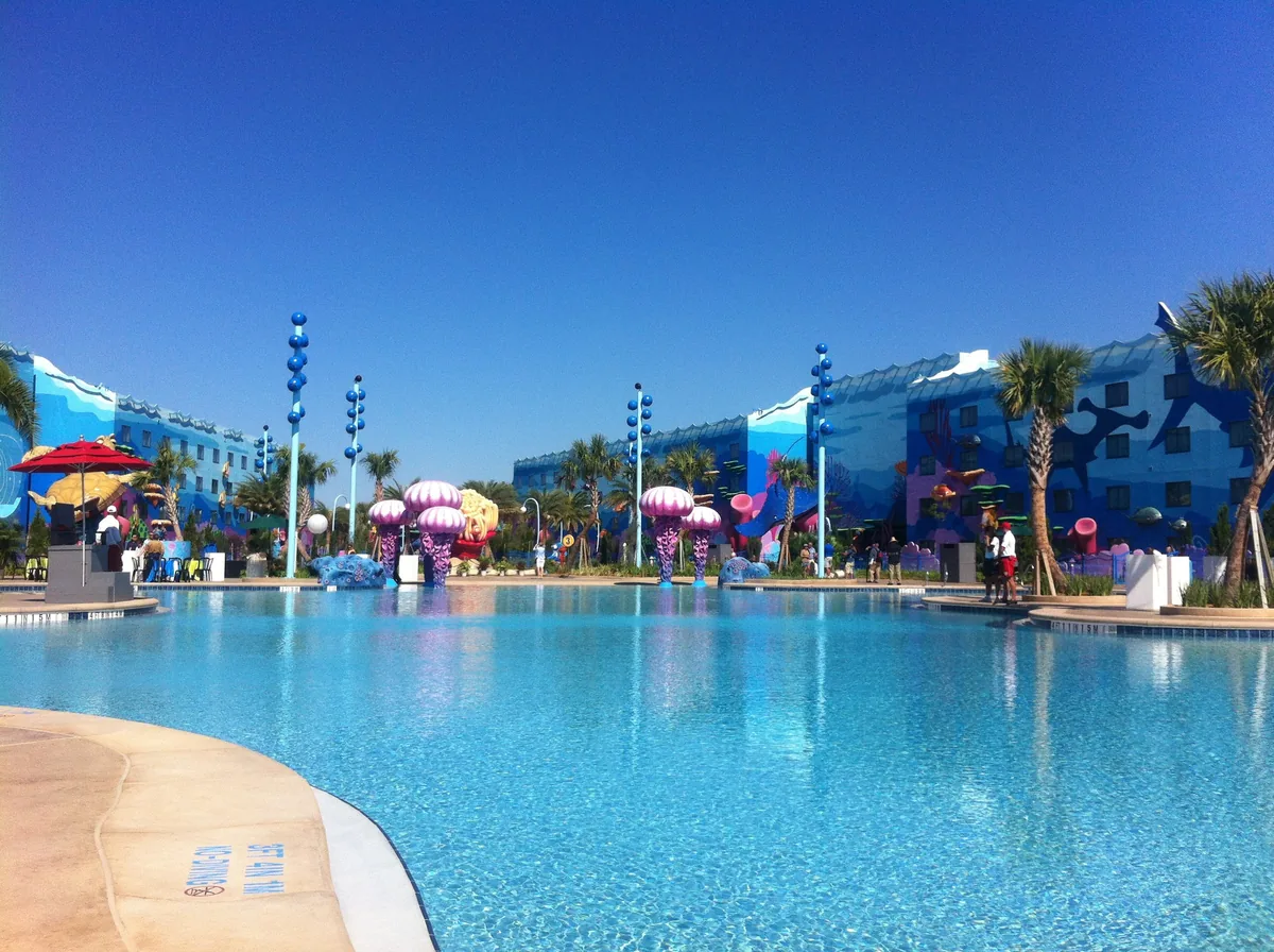 Big Blue Pool at Disney's Art of Animation Resort with jellyfish sculptures and themed buildings