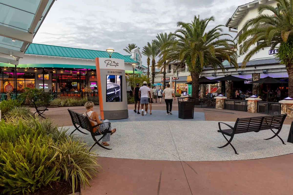 Palm-lined plaza with benches and restaurants at The Pointe Orlando on International Drive