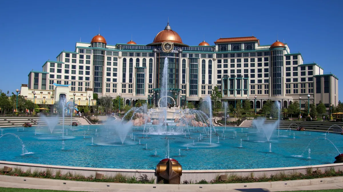 Universal Helios Grand Hotel with copper domes behind the Cosmos Fountain in Epic Universe