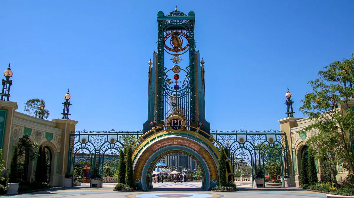 Chronos tower and ornate arched entrance gate of Universal Epic Universe under a clear sky